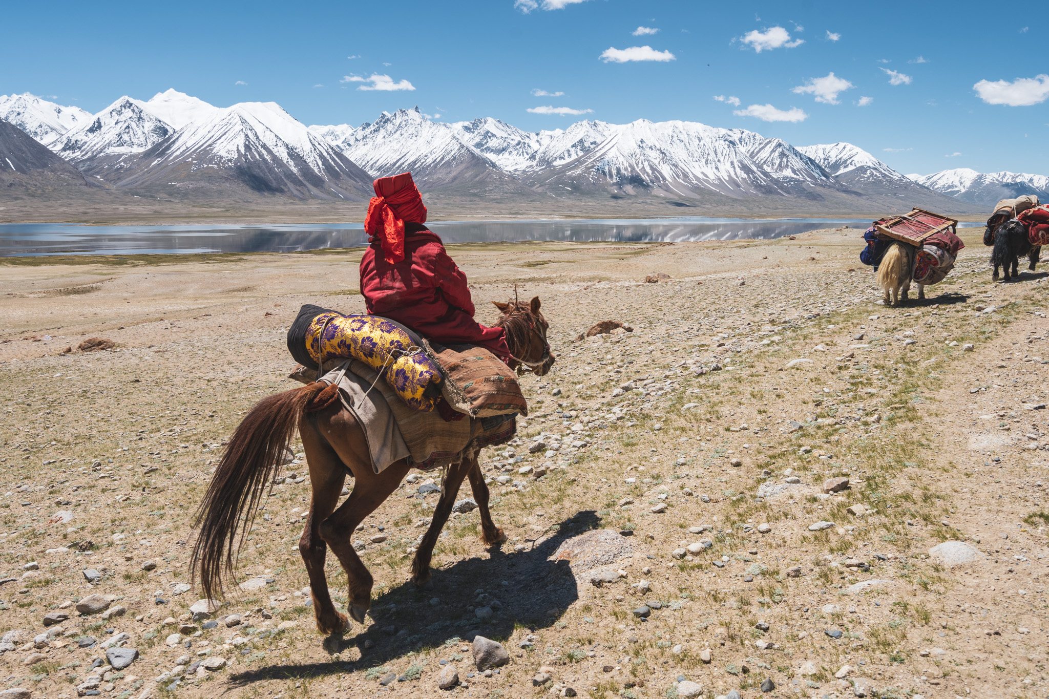 Kyrgyz girl riding her horse by Chaqmaqtin Lake