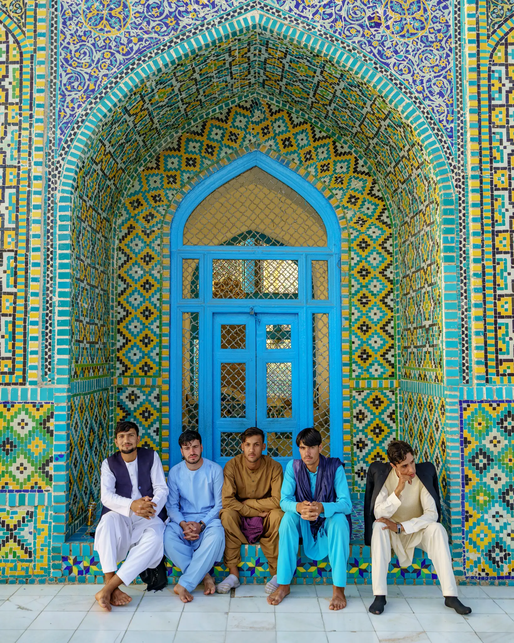 Boys sitting at the Shrine of Hazrat Ali in Mazar-e-Sharif