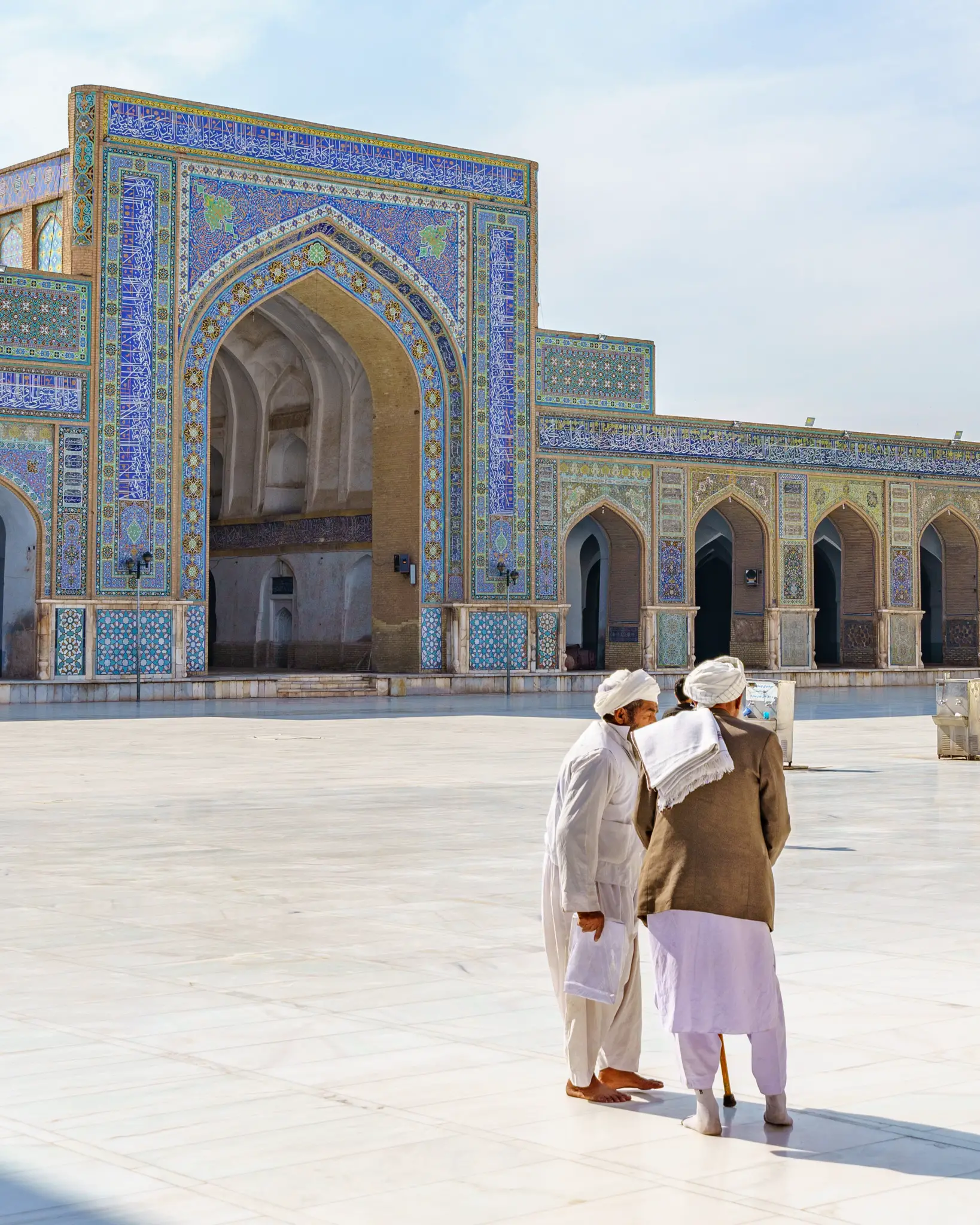 Men hanging out inside the Great Mosque of Herat